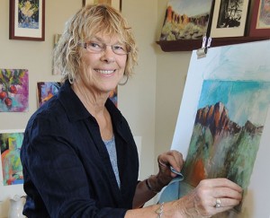 Marty Stewart painting in her studio